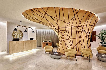 Vestíbulo del NH Collection Palacio de Córdoba con árbol escultórico que integra los pilares estructurales diseñado por Paolo Mauri