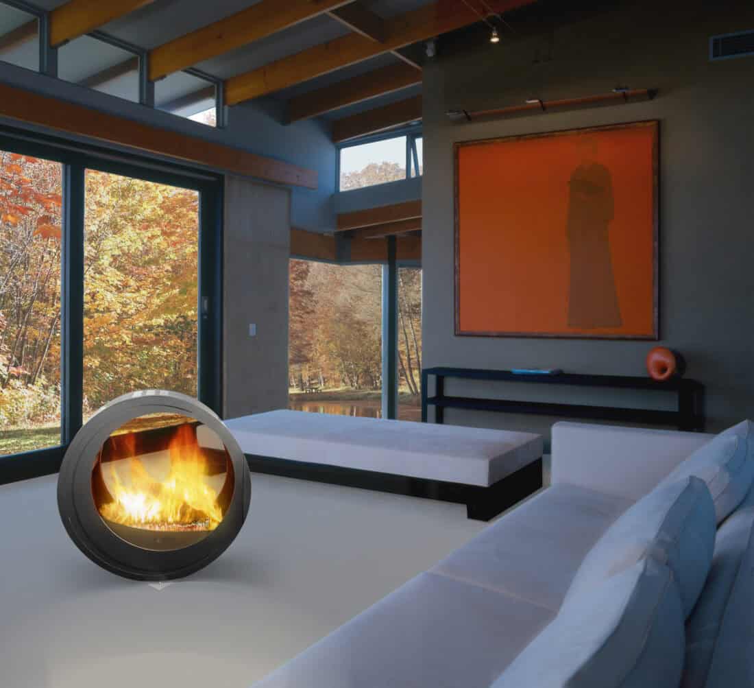 (chimenea Eclypsya en salón) Chimenea de leña nómada Arkiane modelo Eclypsya de diseño circular en salón contemporáneo con vistas al jardín otoñal