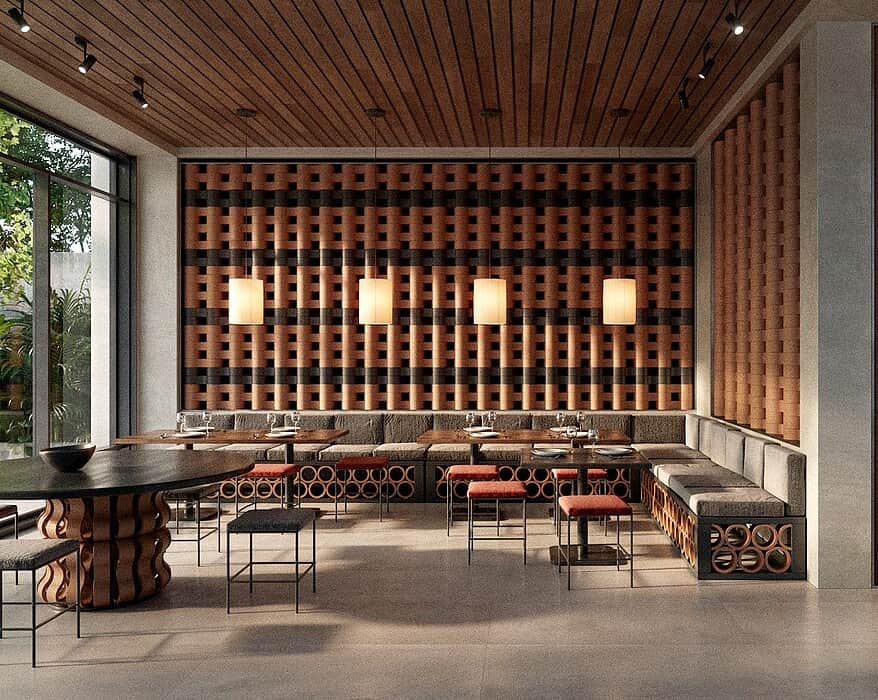 Interior de restaurante con sistema modular cerámico O-Buit de Gresmanc Group, con piezas extrusionadas en terracota formando composición tridimensional en pared de fondo